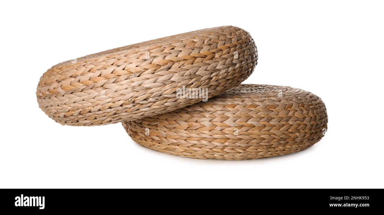 Two stylish wicker poufs on white background Stock Photo