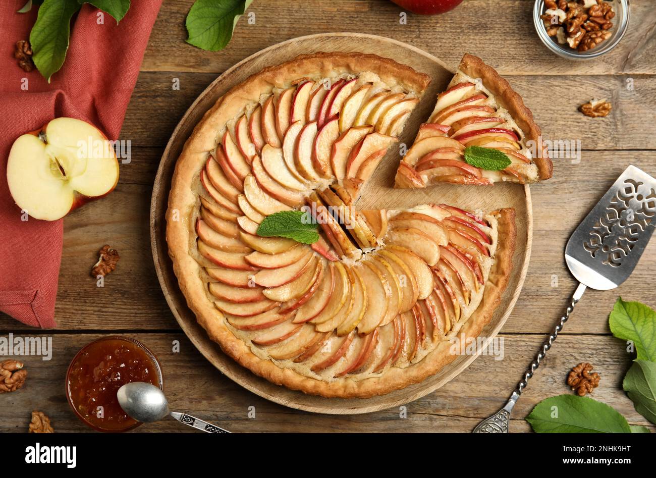 Delicious apple pie and ingredients on wooden table, flat lay Stock Photo