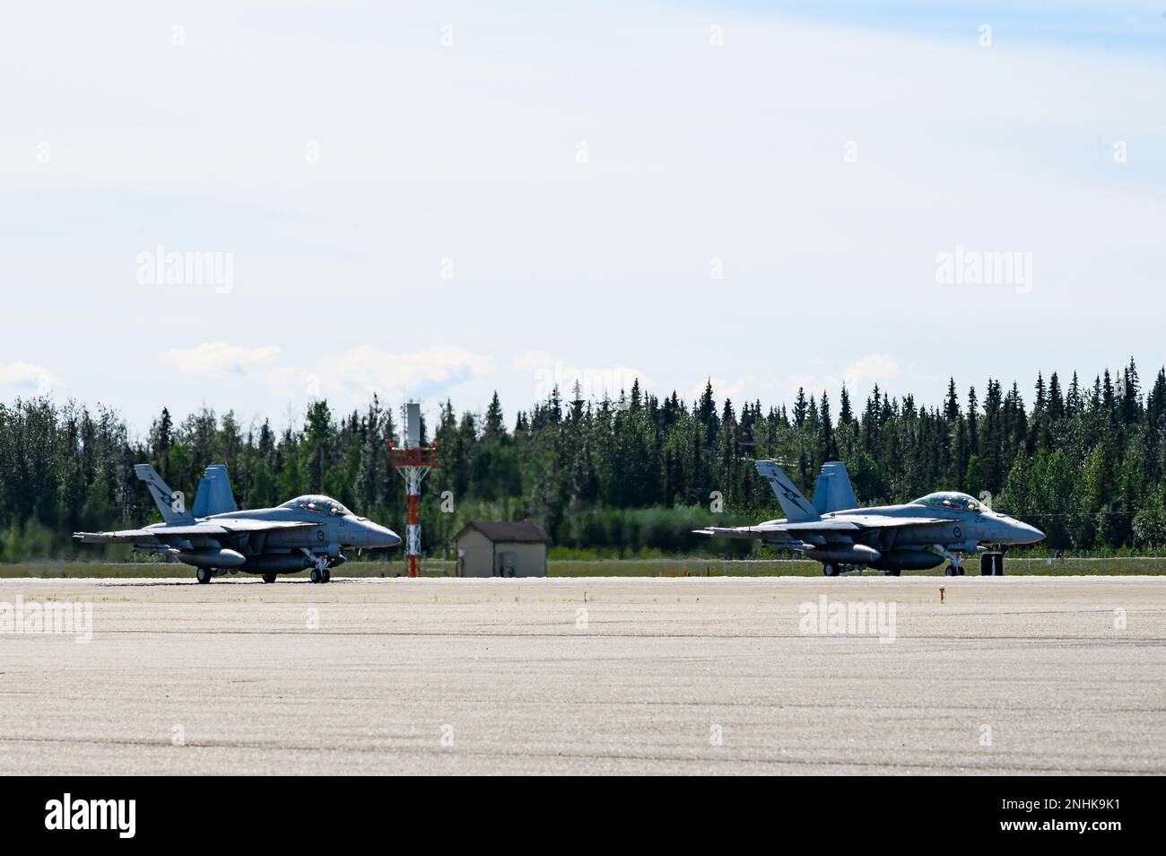 Two Royal Australian Air Force F/A-18F Super Hornets sit on the flightline during RED FLAG-Alaska 22-3 on Eielson Air Force Base, Alaska, July 29, 2022. RF-A serves as an ideal platform for international engagement, enabling the exchange of tactics, techniques and procedures while improving interoperability to maintain a free and open Indo-Pacific. Stock Photo