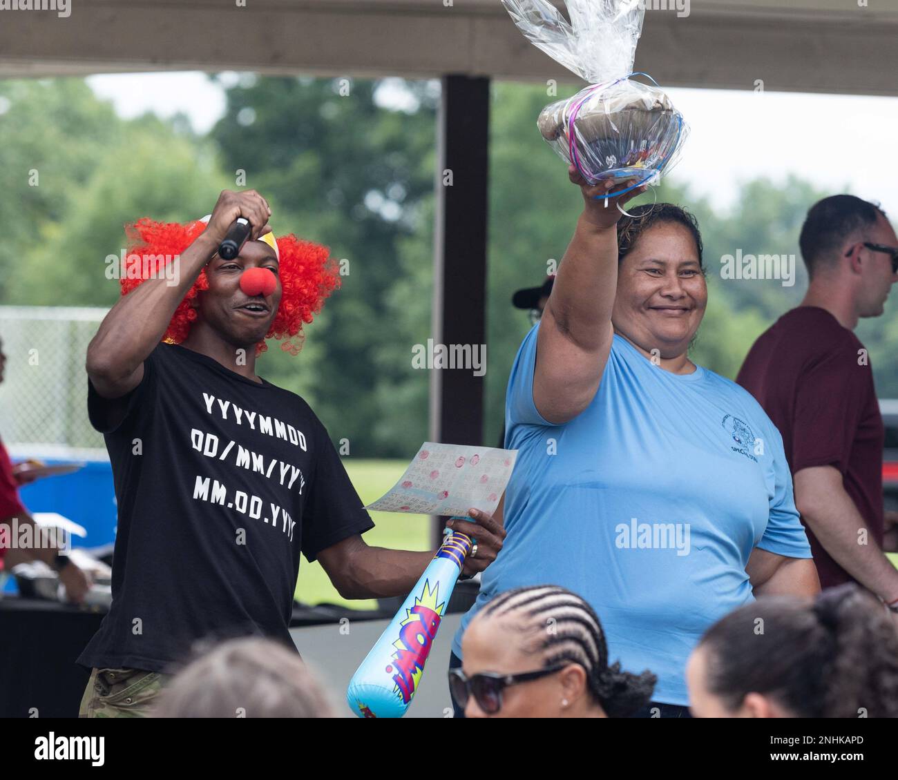 One of clowns at 1st Theater Sustainment Command Organizational Day 2022 awards a prize during