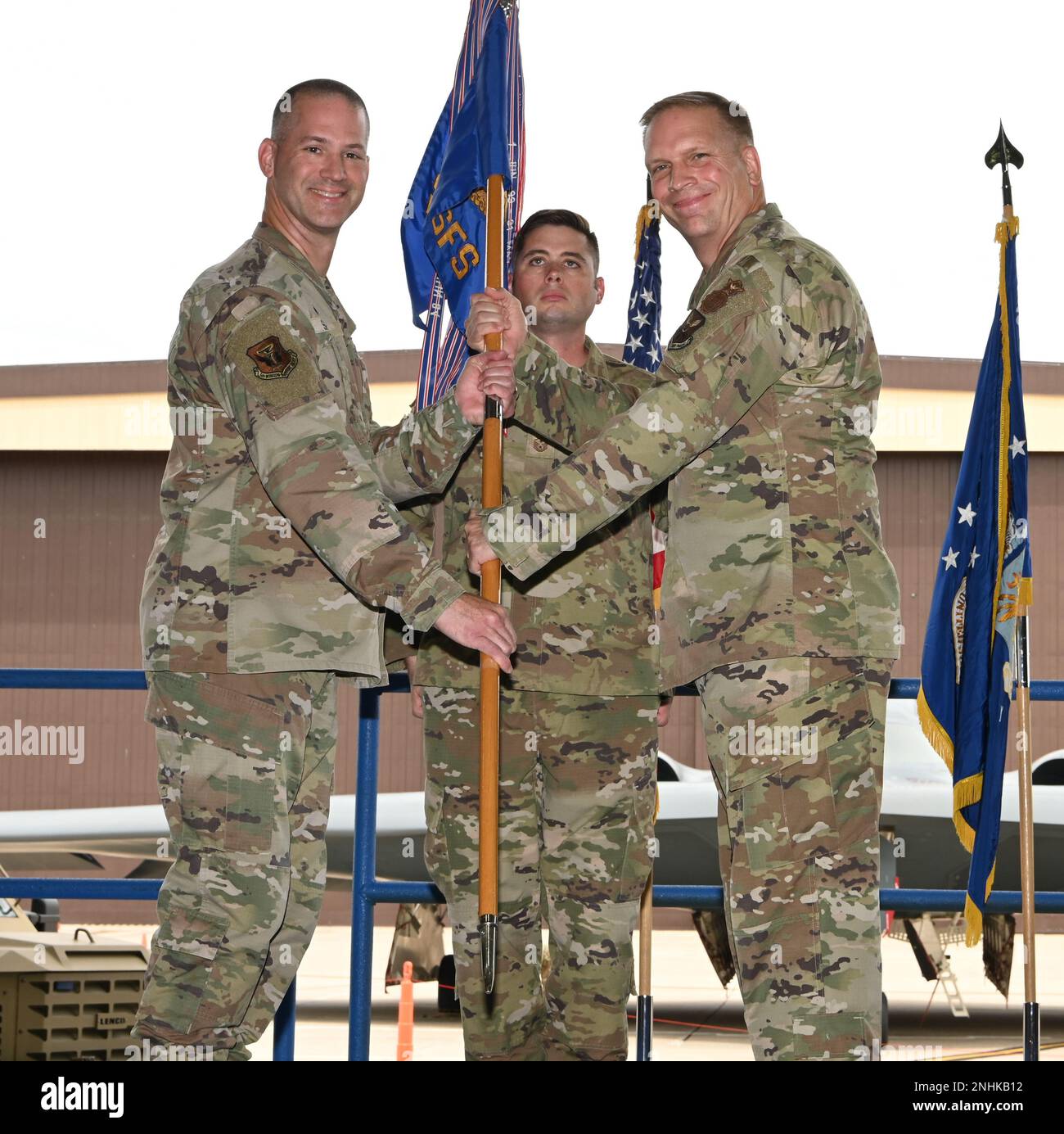 Col. Christopher Schlak, 509th Mission Support Group commander(left), passes the guidon to Lt