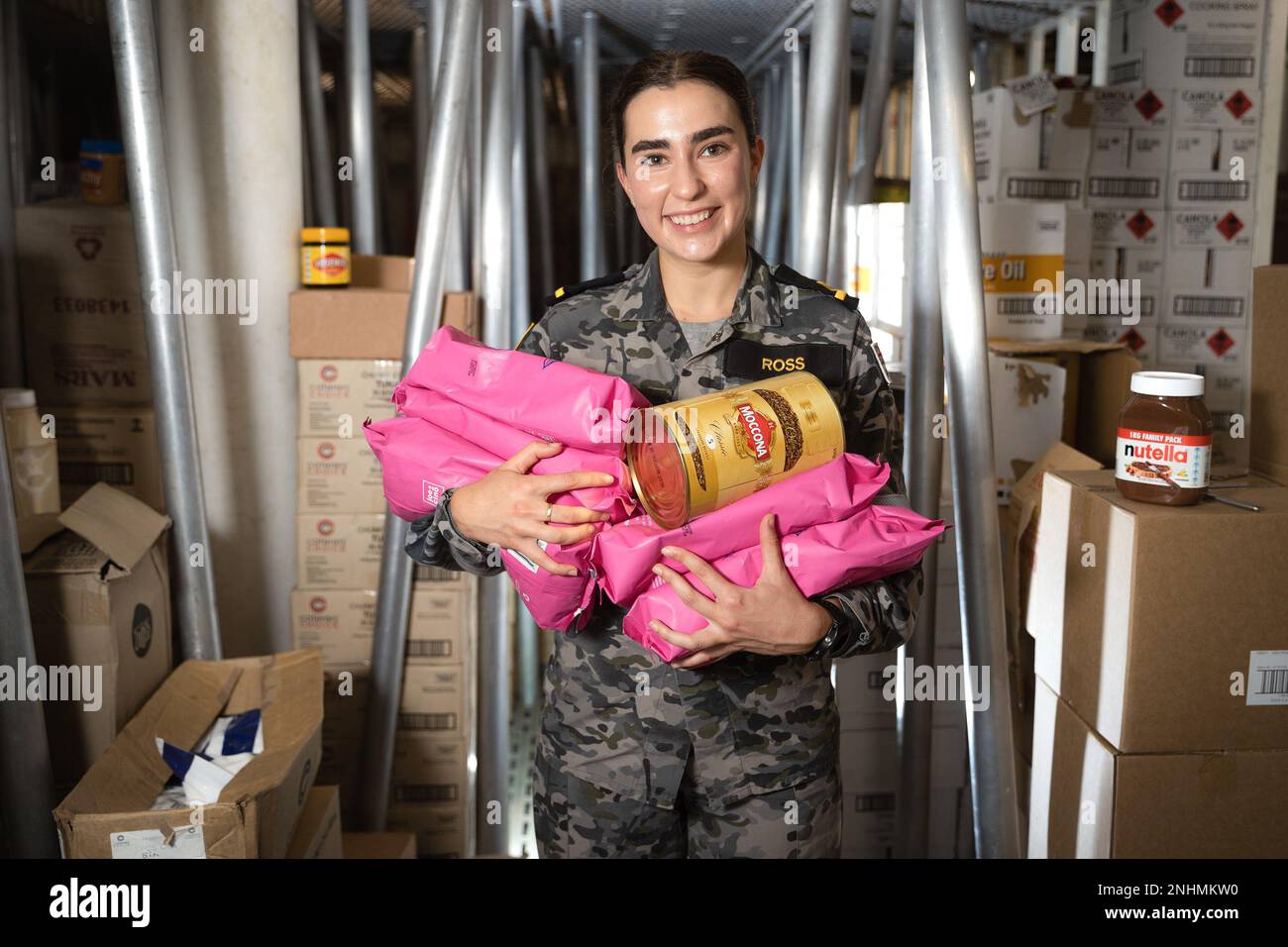PACIFIC OCEAN (July 20, 2022) Royal Australian Navy Maritime Logistics Officer Sub-Lt. Amelia Ross holds an assortment of coffee products in the dry store of Royal Australian Navy Canberra-class landing helicopter dock HMAS Canberra (L02) during Rim of the Pacific (RIMPAC). Twenty-six nations, 38 ships, three submarines, more than 170 aircraft and 25,000 personnel are participating in RIMPAC from June 29 to Aug. 4 in and around the Hawaiian Islands and Southern California. The world's largest international maritime exercise, RIMPAC provides a unique training opportunity while fostering and sus Stock Photo