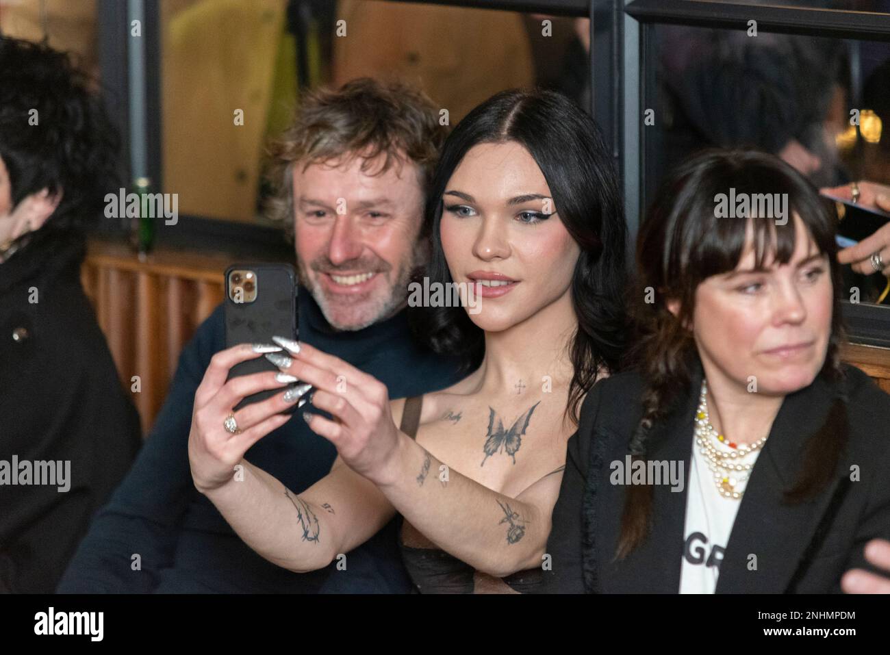 Guests at a VIN+OMI fashion show taking a selfie. Fashion event in One