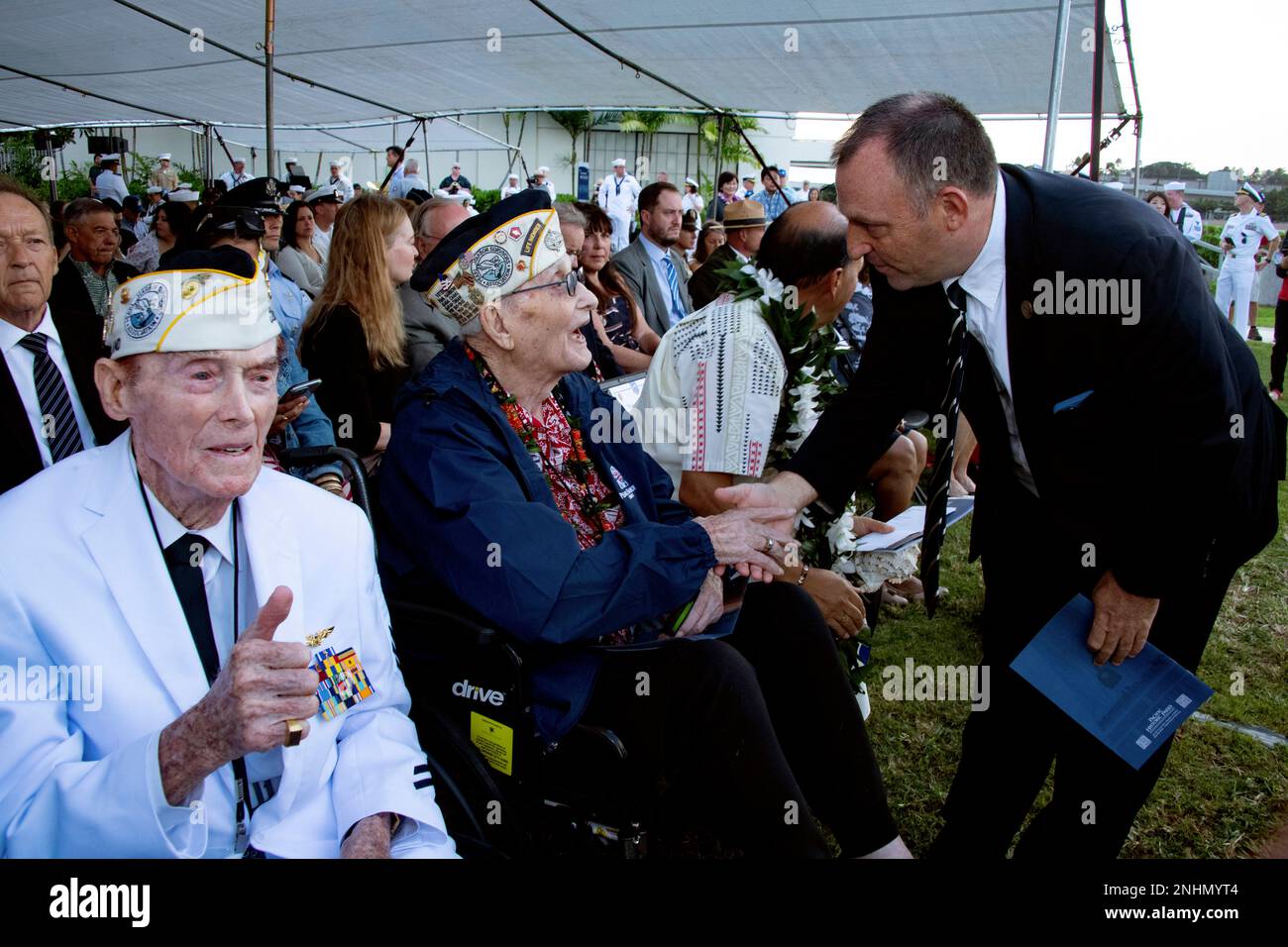 Pearl Harbor survivor Jack Holder, left, gestures as fellow survivor