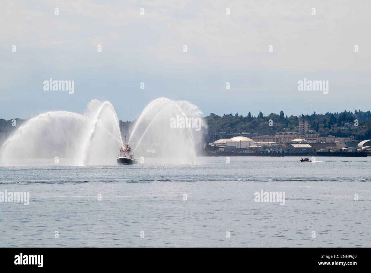 Seattle Fire Department Fireboat Leschi sprays water as ships arrive in Seattle for Fleet Week, Aug. 1, 2022. Fleet Week Seattle is a time-honored celebration of the sea services and provides an opportunity for the citizens of Washington to meet Sailors, Marines and Coast Guardsmen, as well as witness firsthand the latest capabilities of today's maritime services. Stock Photo