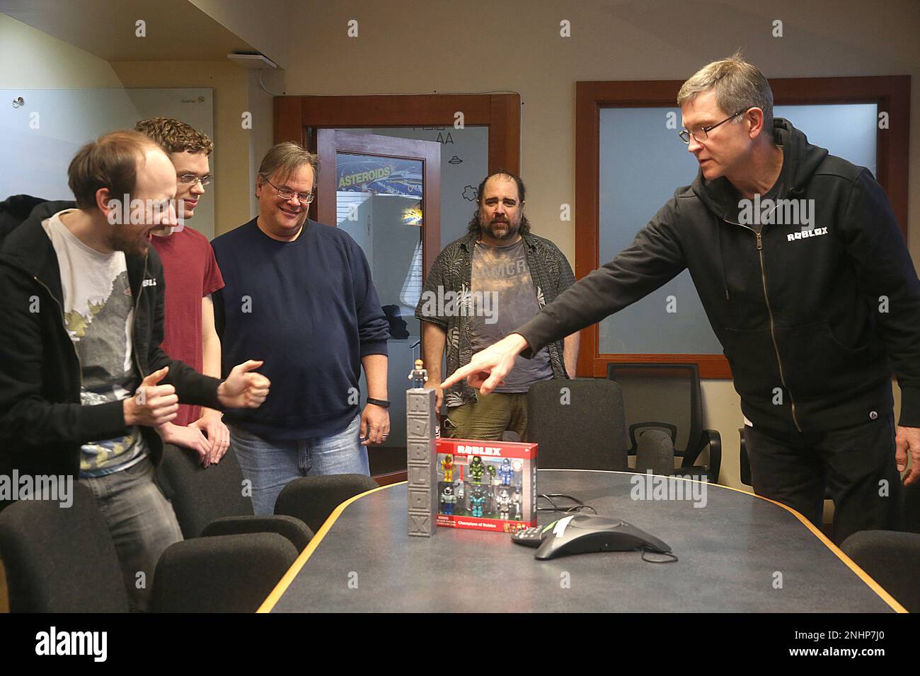 CEO David Baszucki (right) of Roblox gives the creative product team their  first view of the packaging for their new release of a line of physical  toys coming early next month, designed