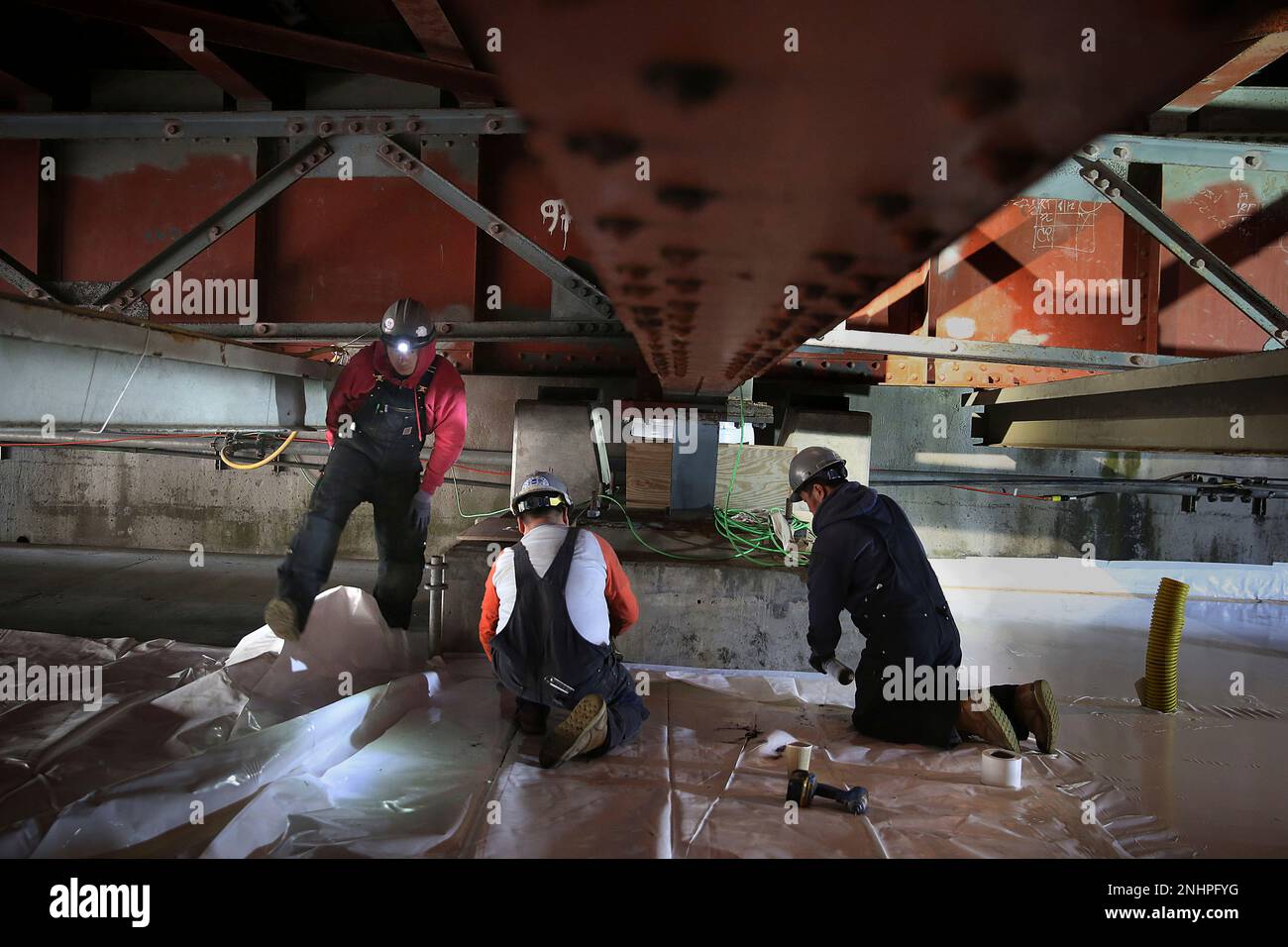 Bridge ironworkers Andy Zhen (left), Quan Du (middle), and Steve Thang