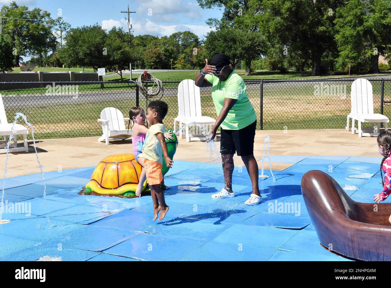 Milka Karanja (right), Fort Polk FFC provider, watches Ailey Coffee (left) and Donald Hetland (second on left) as they enjoy a warm summer morning at Fort Polk’s Splash Park. Stock Photo