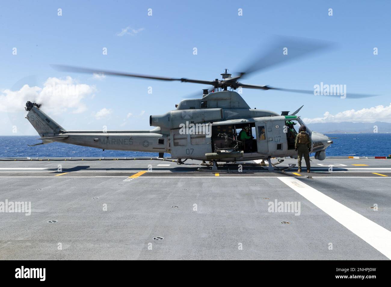 PACIFIC OCEAN (Aug. 1, 2022) A U.S. Marine Corps UH-1Y Venom helicopter refuels on the flight deck of Royal Australian Navy Canberra-class landing helicopter dock HMAS Canberra (L02)   during Rim of the Pacific (RIMPAC) 2022. Twenty-six nations, 38 ships, three submarines, more than 170 aircraft and 25,000 personnel are participating in RIMPAC from June 29 to Aug. 4 in and around the Hawaiian Islands and Southern California. The world's largest international maritime exercise, RIMPAC provides a unique training opportunity while fostering and sustaining cooperative relationships among participa Stock Photo