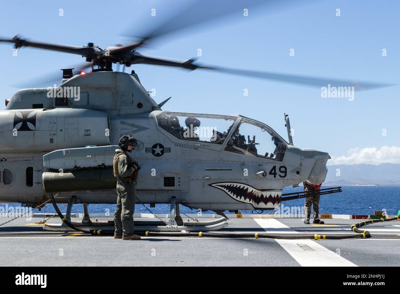 PACIFIC OCEAN (Aug. 1, 2022) A U.S. Marine Corps AH-1Z Viper helicopter refuels on the flight deck of Royal Australian Navy Canberra-class landing helicopter dock HMAS Canberra (L02) during Rim of the Pacific (RIMPAC) 2022. Twenty-six nations, 38 ships, three submarines, more than 170 aircraft and 25,000 personnel are participating in RIMPAC from June 29 to Aug. 4 in and around the Hawaiian Islands and Southern California. The world's largest international maritime exercise, RIMPAC provides a unique training opportunity while fostering and sustaining cooperative relationships among participant Stock Photo