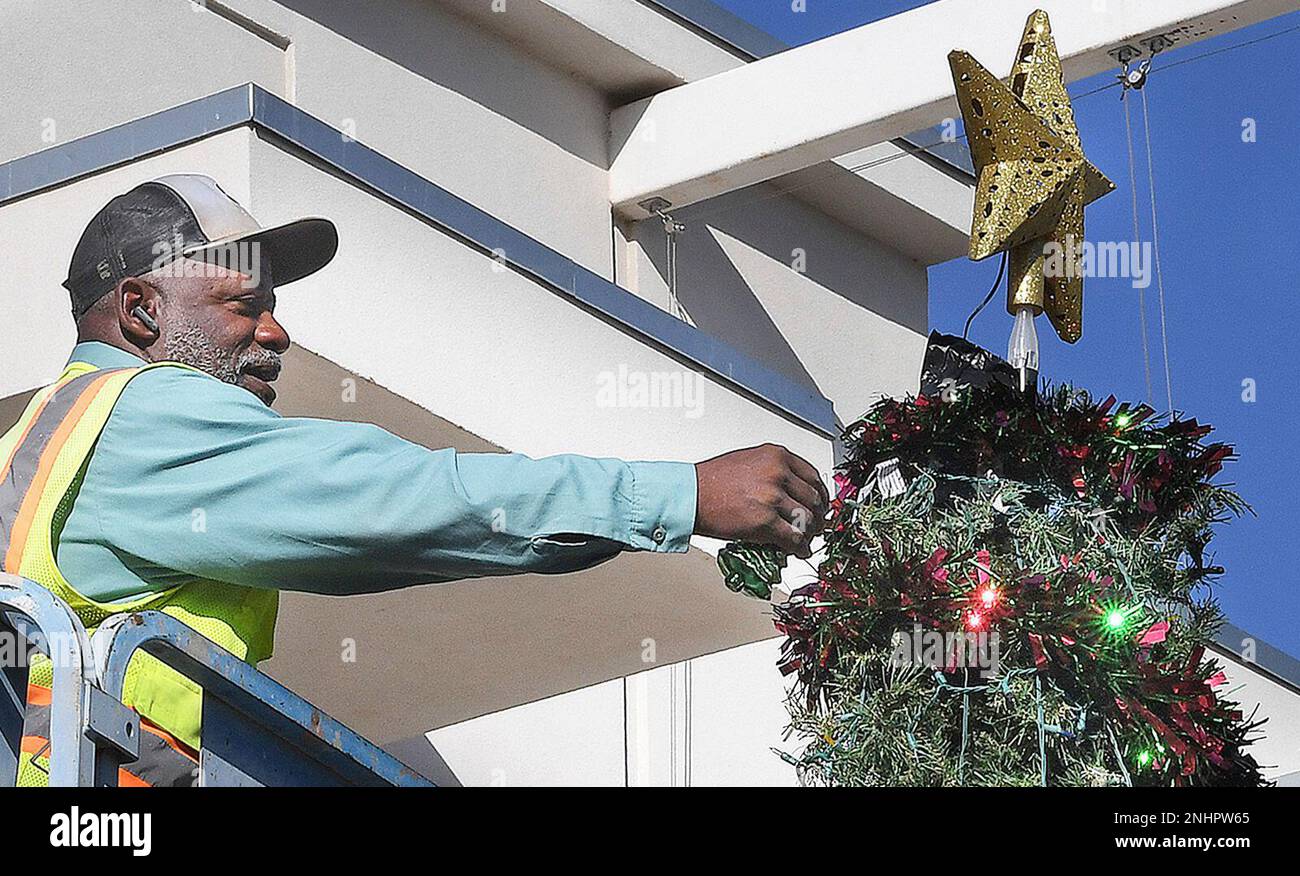 Rod Ford of Yuma, Ariz., Parks and Recreation places an ornament on the