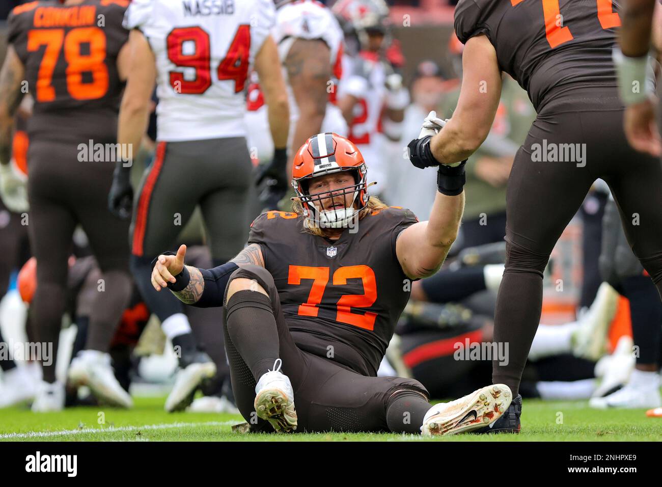 CLEVELAND, OH - NOVEMBER 27: Cleveland Browns guard Hjalte Froholdt (72)  gets a hand up from Cleveland Browns guard Wyatt Teller (77) during the  first quarter of the National Football League game