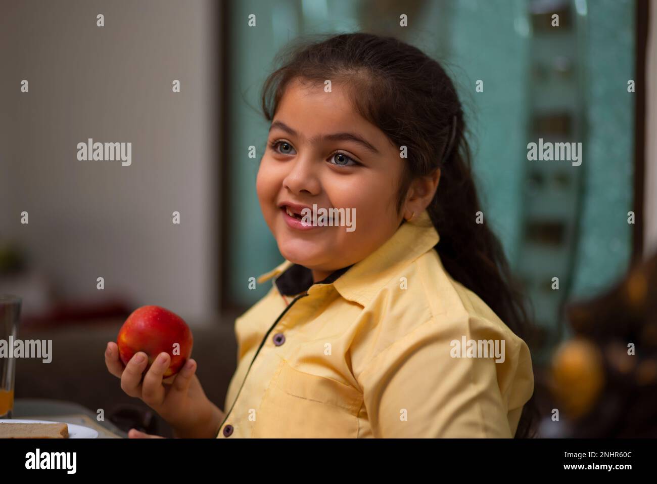 Indian girl eating apple hires stock photography and images Alamy
