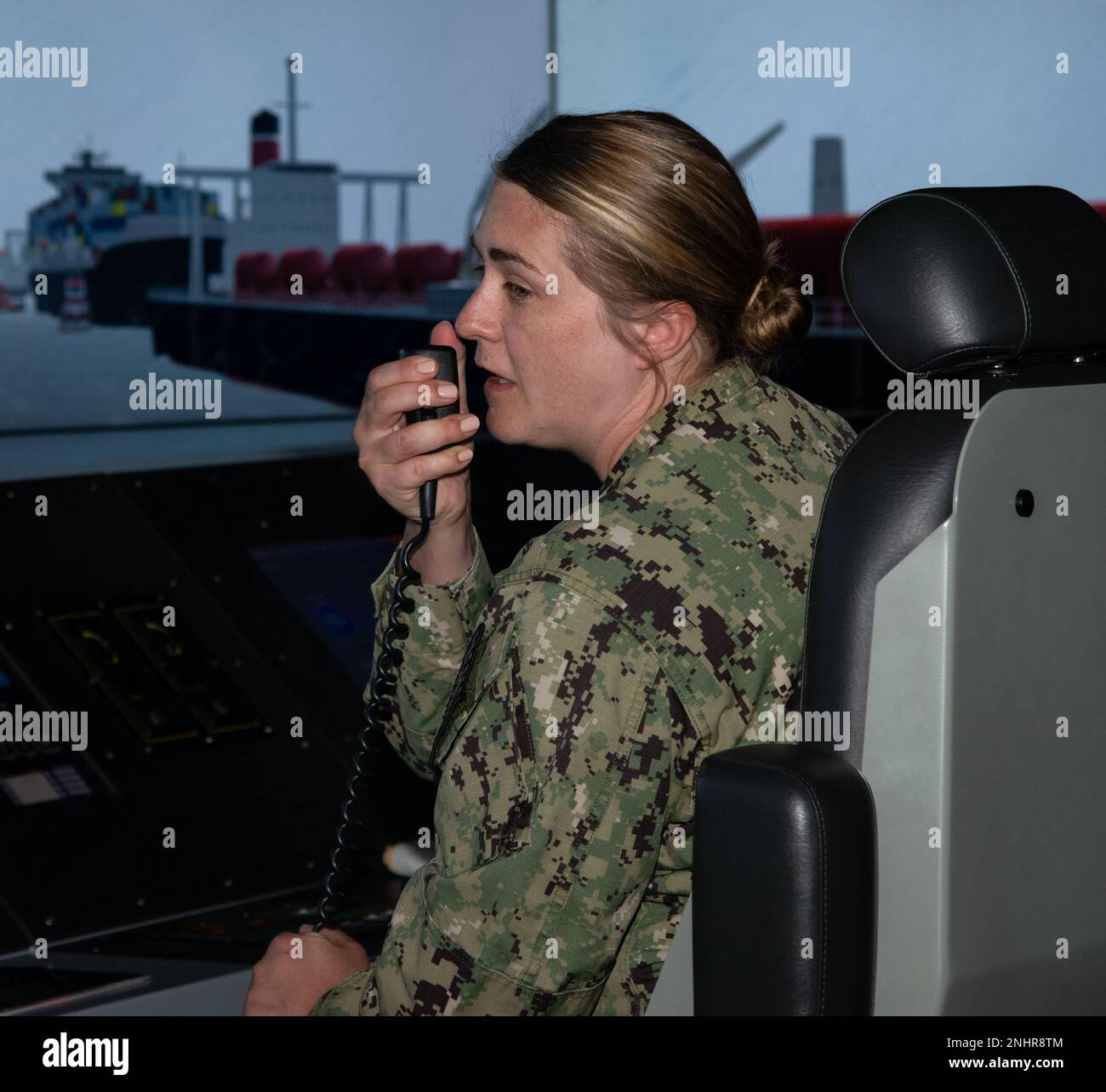 NEWPORT, R.I. (Aug. 1, 2022) Cmdr. Angela Eickelmann, a student at Surface Warfare Schools Command (SWSC) in Newport, Rhode Island, acts as junior officer of the deck during a ship driving simulation in the littoral combat ship bridge part-task trainer, Aug. 1, 2022. SWSC provides a continuum of professional education and training to ready sea-bound warriors to serve on surface combatants as officers, enlisted engineers, and enlisted navigation professionals. Stock Photo