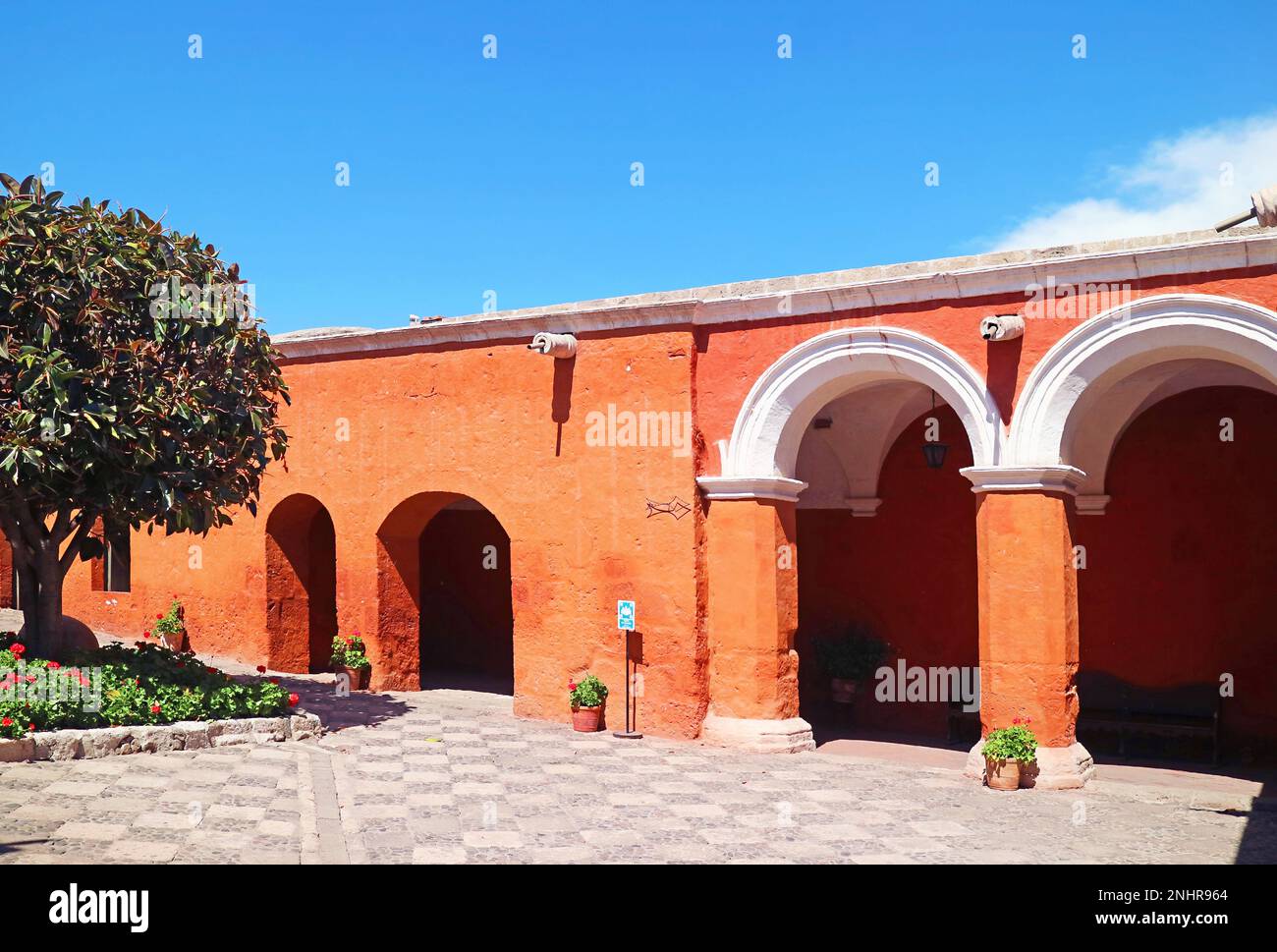 Stunning Cloister with Orange Red Colored Stone Archway of the Convent of Santa Catalina de Siena in Arequipa, Peru, South America Stock Photo