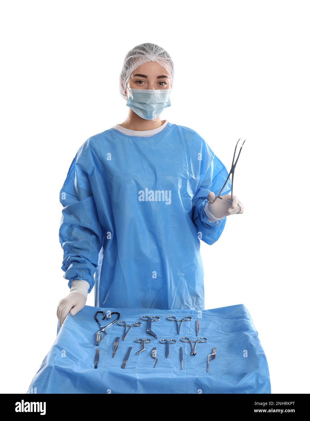 Doctor holding medical clamps near table with different surgical