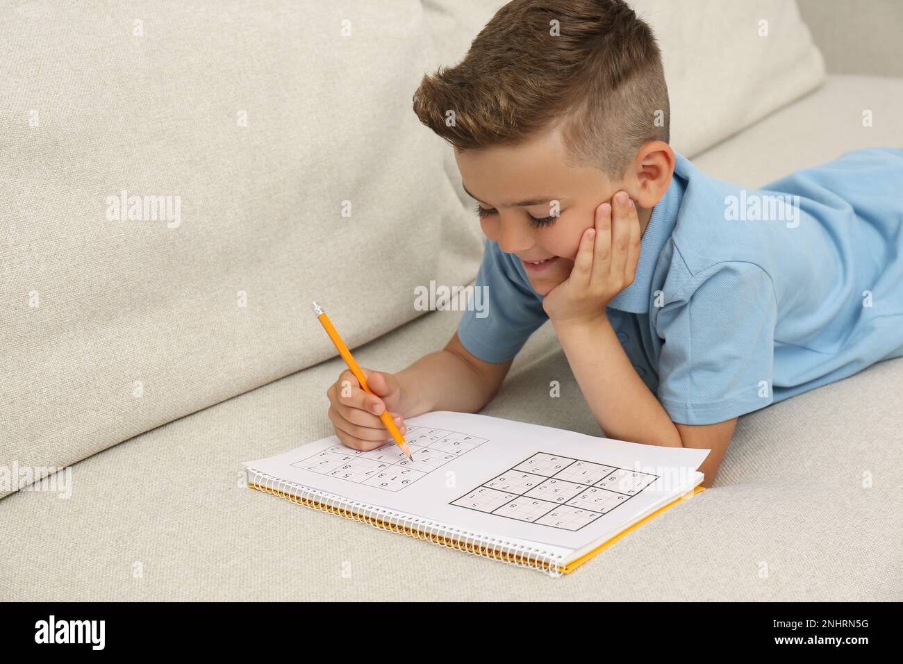 Little Boy Solving Sudoku Puzzle On Sofa At Home Stock Photo Alamy Little boy solving sudoku puzzle on sofa at home stock photo alamy