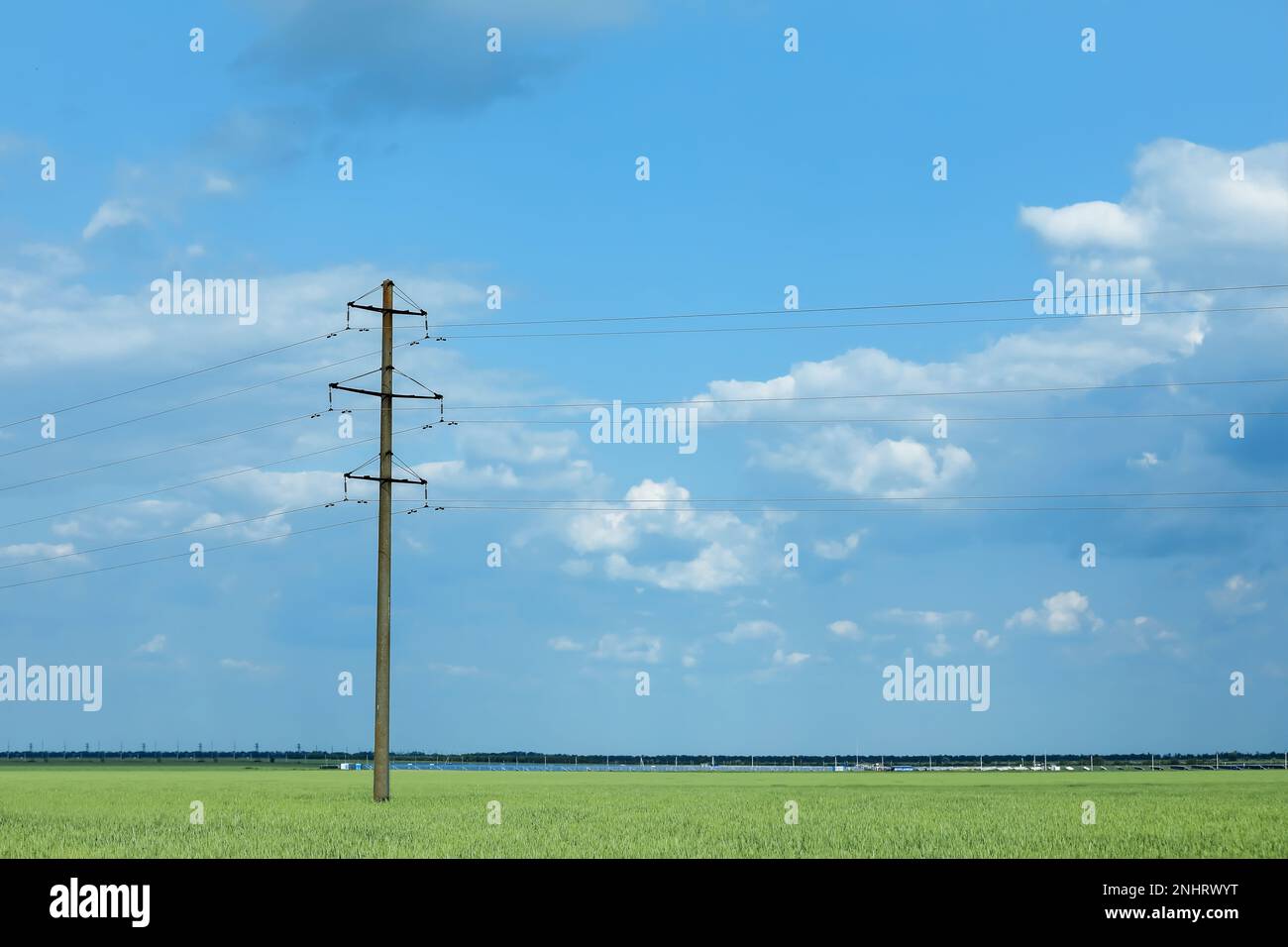 Field with telephone pole under cloudy sky Stock Photo Alamy