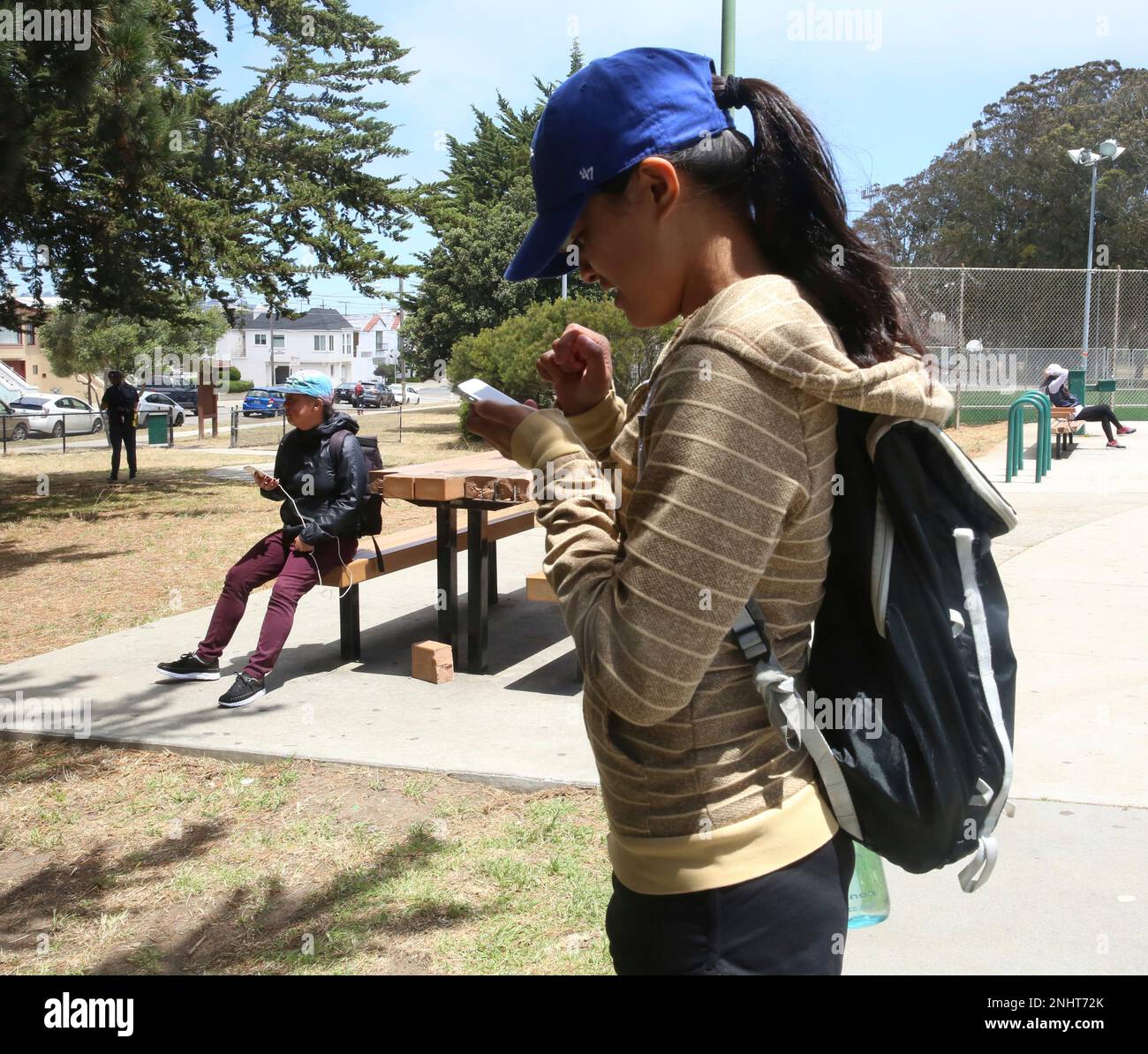 Kristina Liwanag (blue cap), 22 years old, catches lures playing Pokemon Go  at Crocker Amazon park on Monday, July 11, 2016 in San Francisco, Calif.  (Liz Hafalia/San Francisco Chronicle via AP Stock
