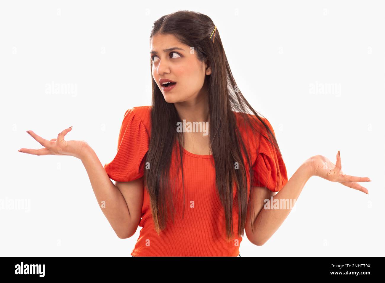 Portrait of beautiful woman shrugging against white background Stock Photo