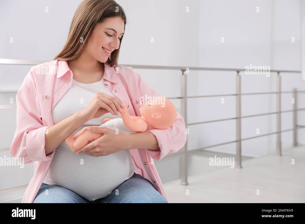 Pregnant woman with doll at courses for expectant mothers indoors Stock  Photo - Alamy