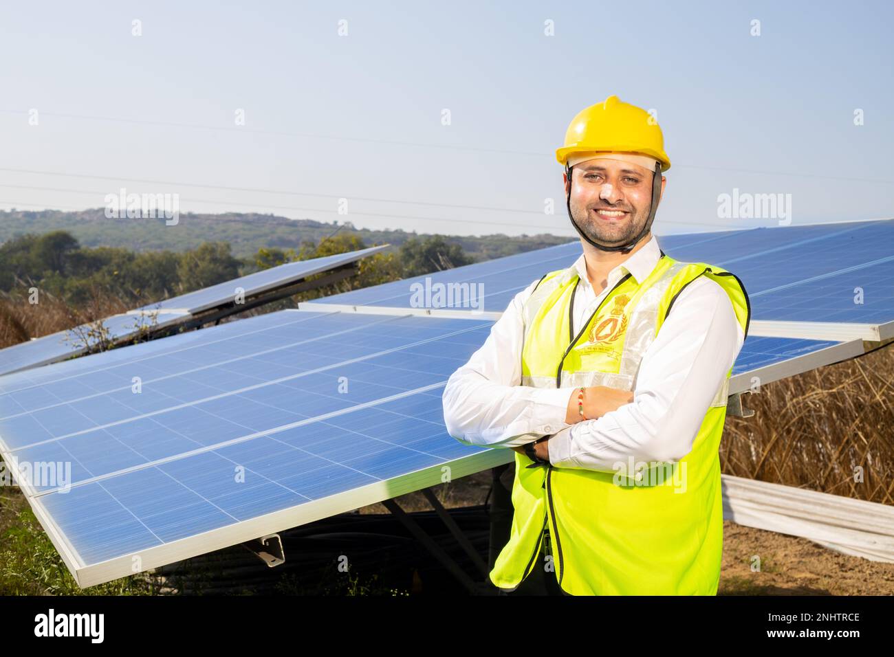 Portrait of Young indian man technician wearing yellow hard hat