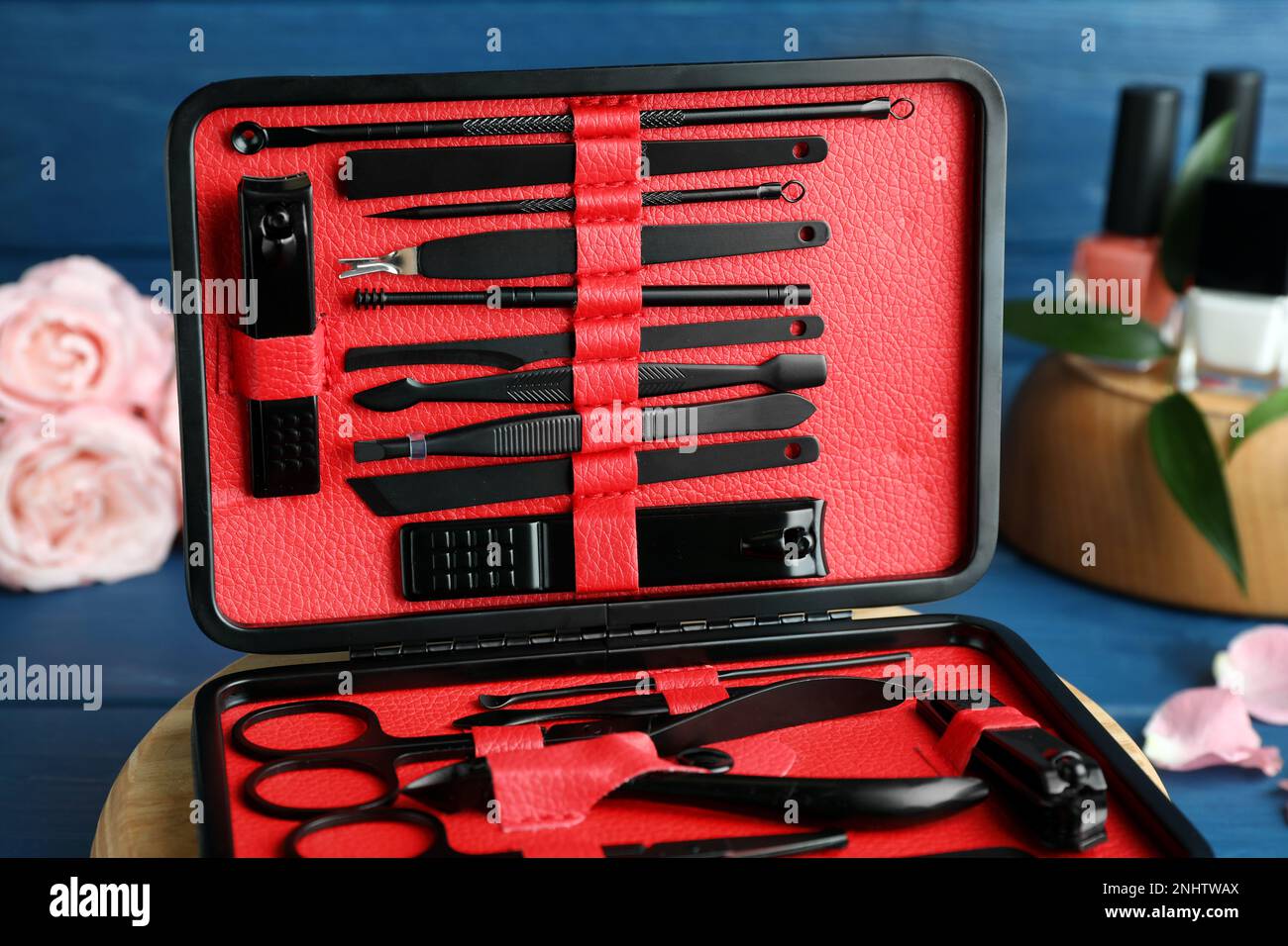 Manicure set in case on blue table, closeup Stock Photo