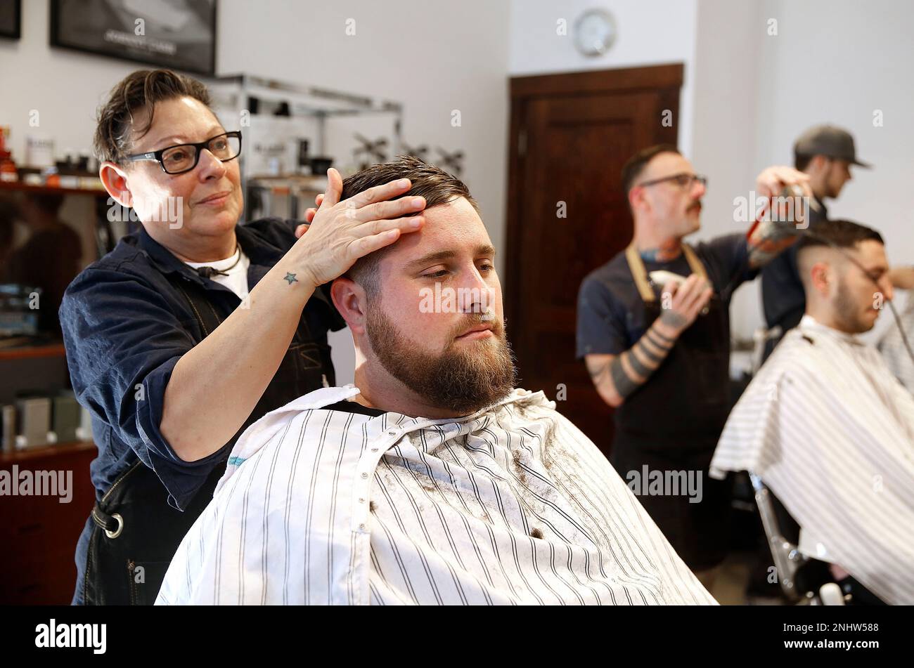Master barber Susan D'Arcangelo cuts the hair of Josh Lamb at Blades Co