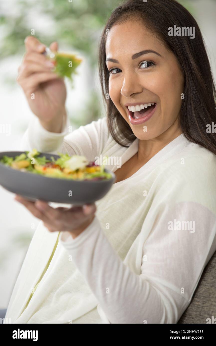 woman eating salad and smiling Stock Photo Alamy