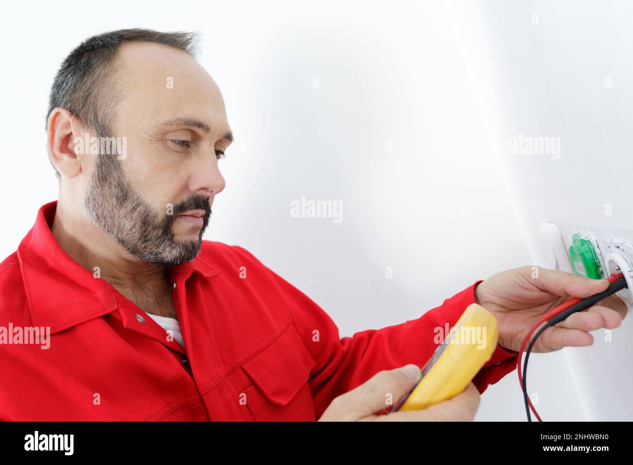 electrician checks the voltage of a socket Stock Photo - Alamy