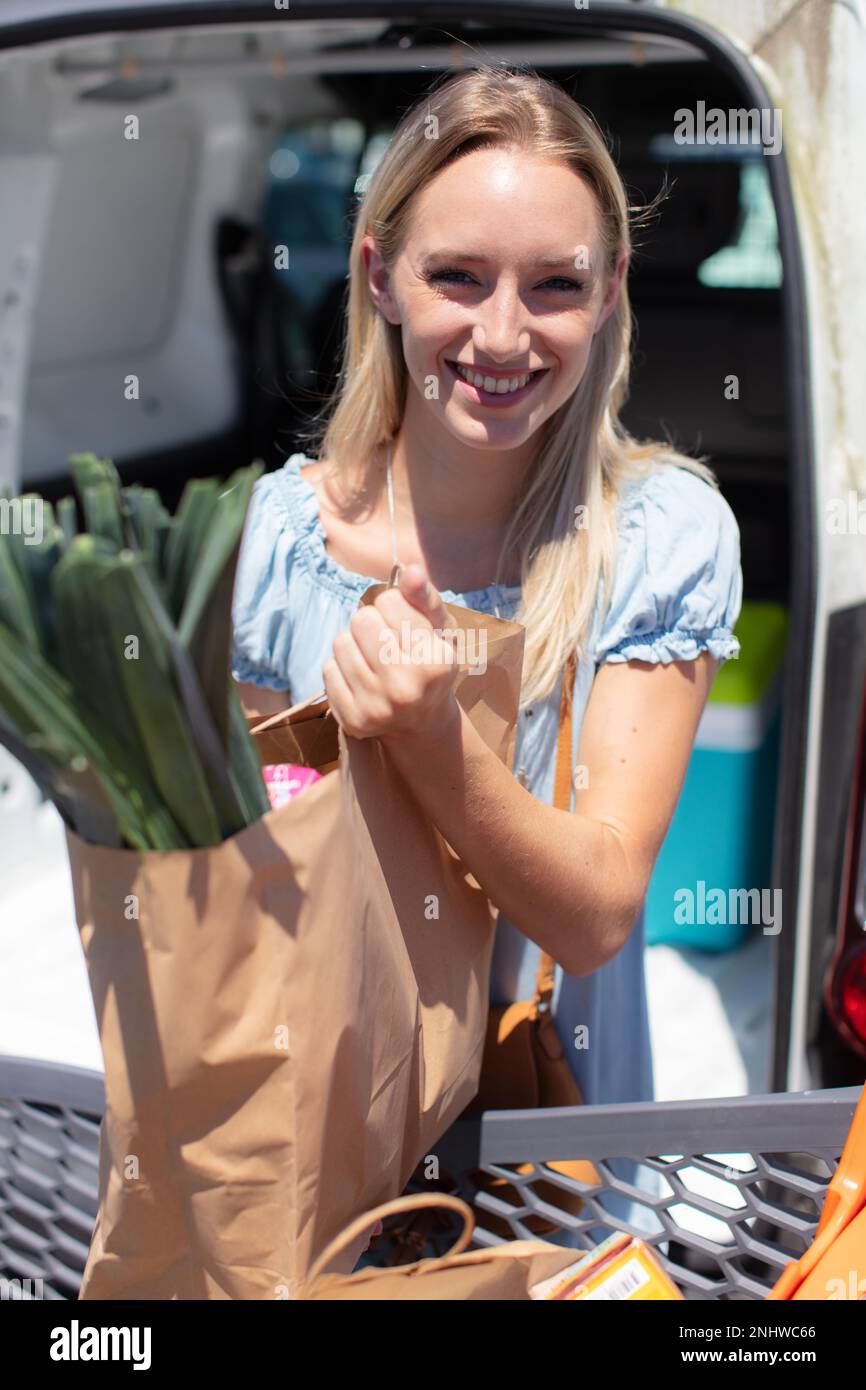 woman unloading groceries in the supermarket carpark Stock Photo Alamy