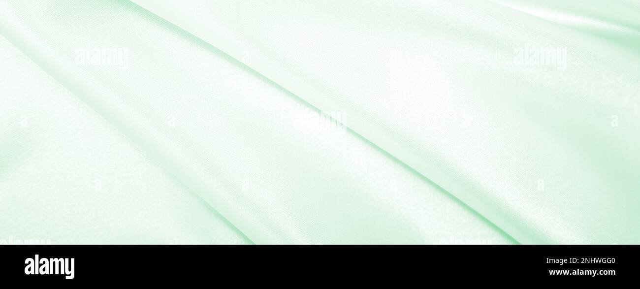 Smooth elegant green silk or satin luxury cloth texture can use as ...