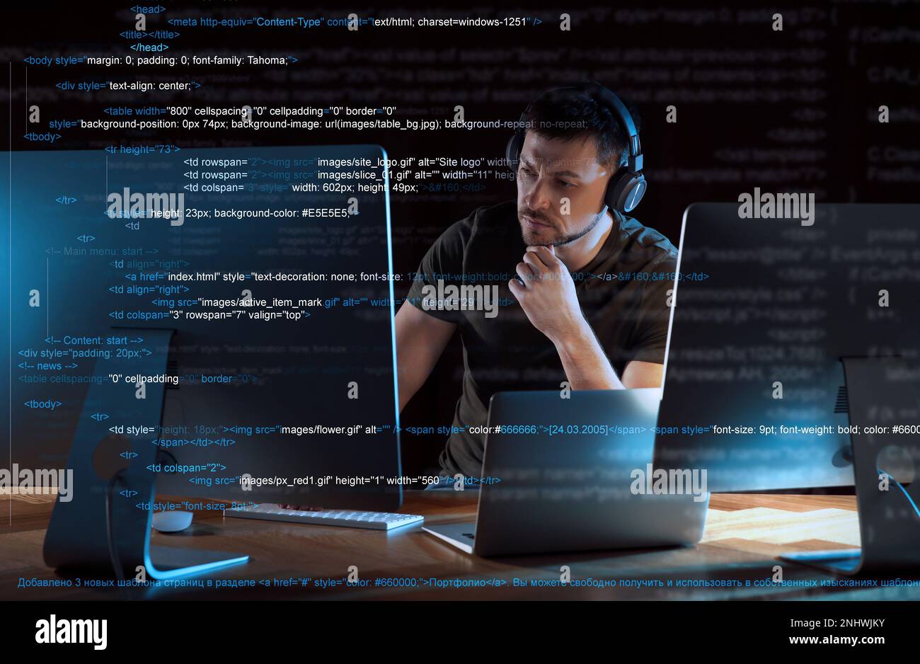 Programmer with headphones working in office at night Stock Photo