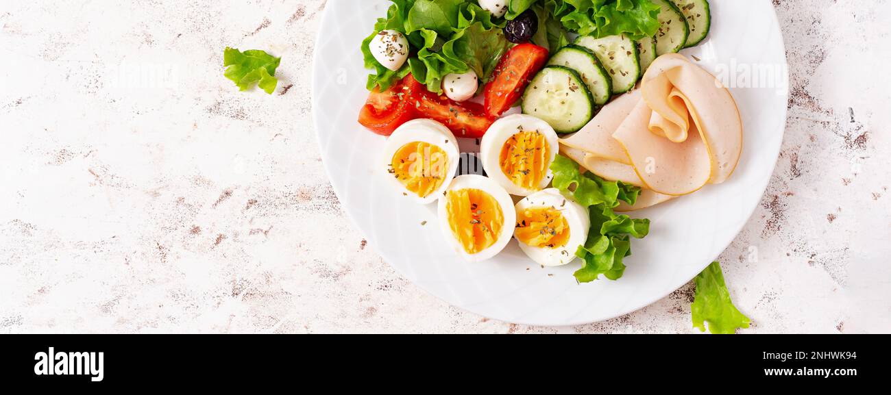 Ketogenic diet. Boiled eggs, ham, mozzarella cheese and fresh salad