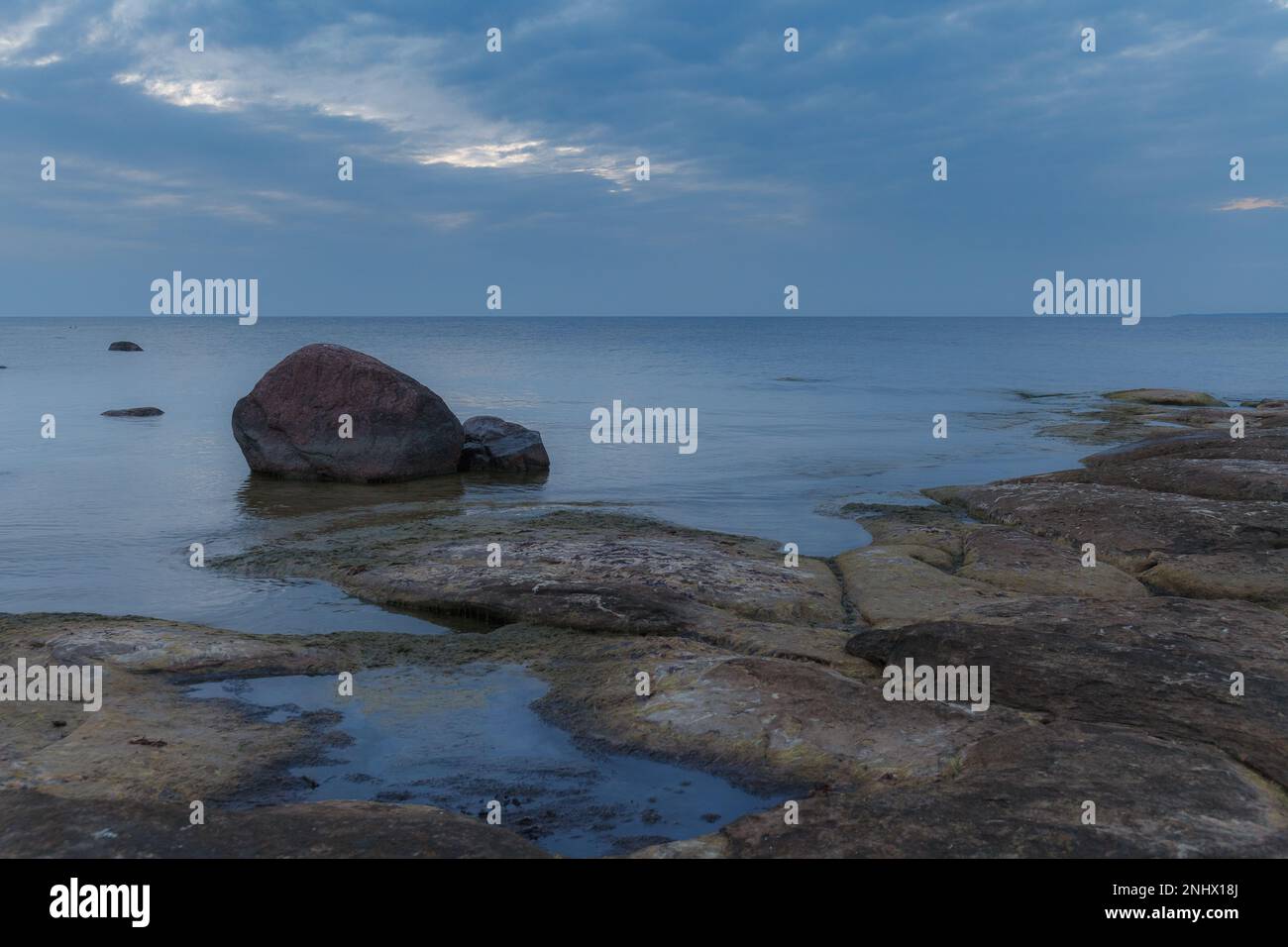 Beautiful sea shore view with with moss-covered rocks. Algae growing on ...