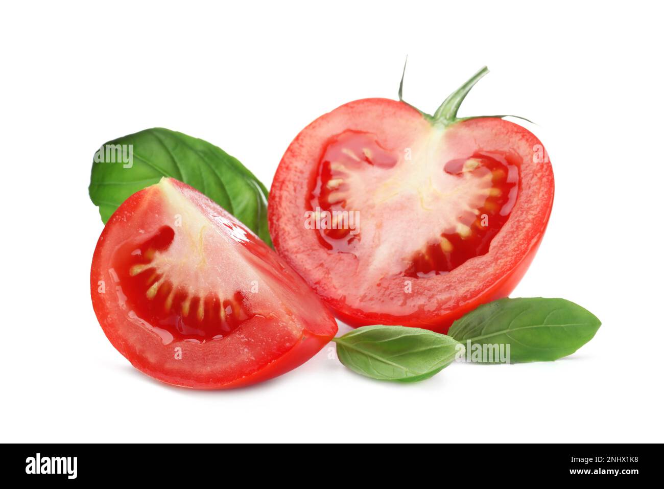Fresh green basil leaves and cut tomato on white background Stock Photo ...