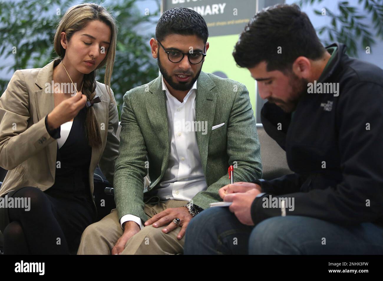 Attorney Nasrina Bargzie (left) and Mokhtar Alkhanshali (right) of Mocha  Mill talk with Chronicle reporter Hamed Aleaziz after arriving at SFO  International airport in South San Francisco, California, after a three day