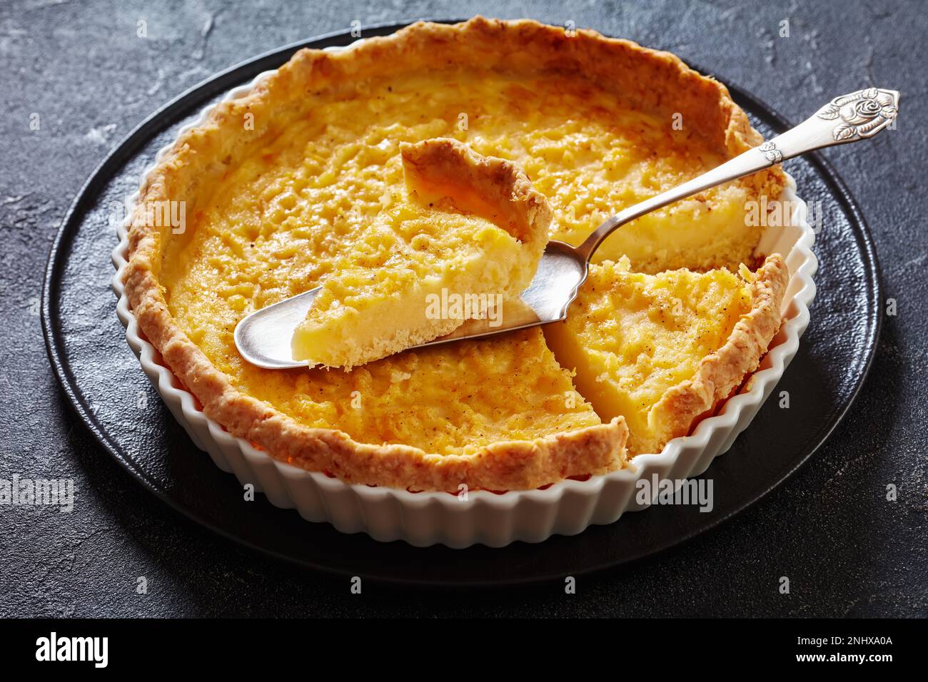 chess pie pairs a traditional butter pie crust with a sweet, custardy filling in white baking dish on concrete table Stock Photo