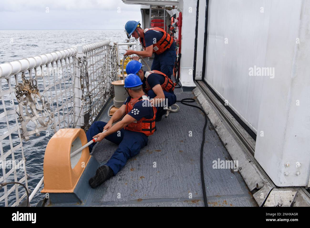 (Front to back) U.S. Coast Guard Seaman Zachary Seidle, Seaman Kanon