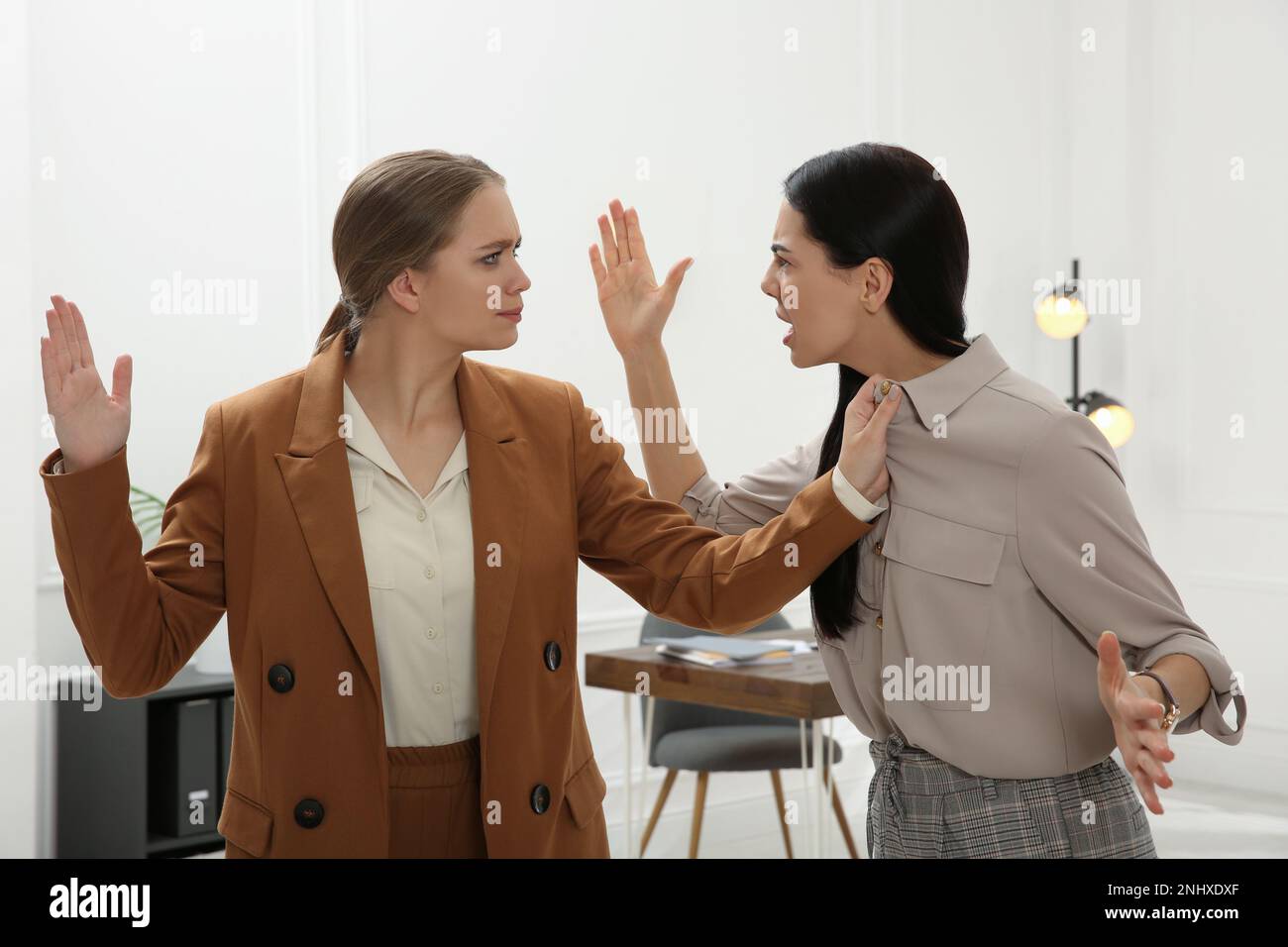 Emotional colleagues fighting in office. Workplace conflict Stock Photo