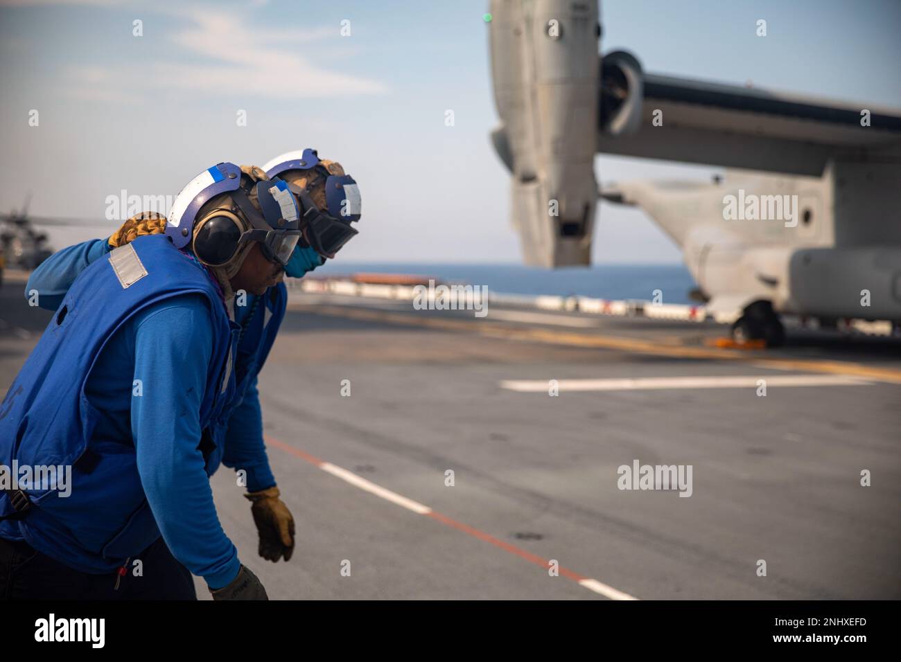 220803-N-HA192-1020  ATLANTIC OCEAN (August 3, 2022) Sailors, assigned to the Wasp-class amphibious assault ship USS Bataan (LHD 5), prepare to secure a MV-22B Osprey assigned to Marine Medium Tiltrotor Squadron 162 to the ship's flight deck, Aug. 3, 2022. Bataan is underway conducting deck landing qualifications and preparations for an upcoming board of inspection and survey evaluation. Stock Photo