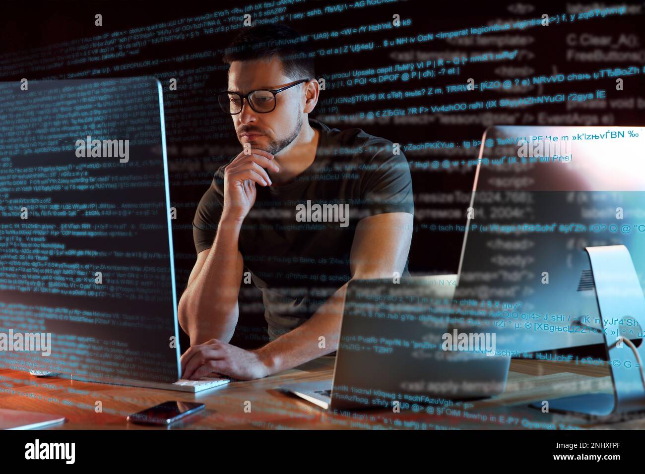 Programmer working in modern office at night Stock Photo