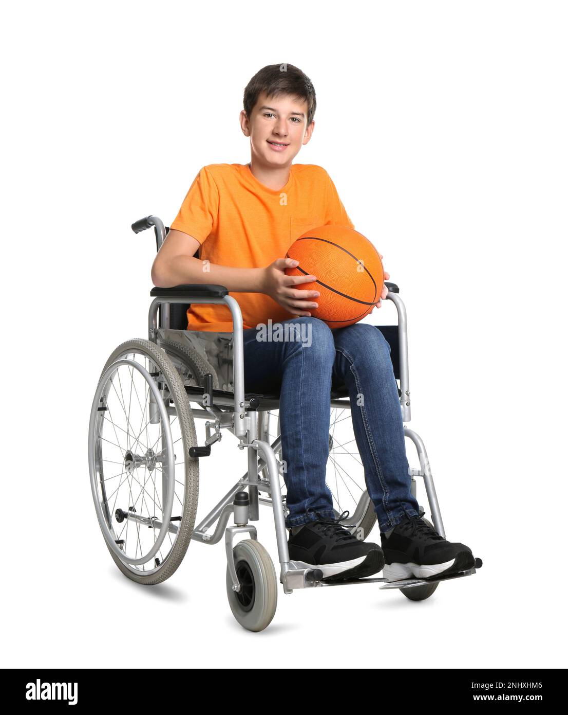 Disabled teenage boy in wheelchair with basketball ball on white background Stock Photo