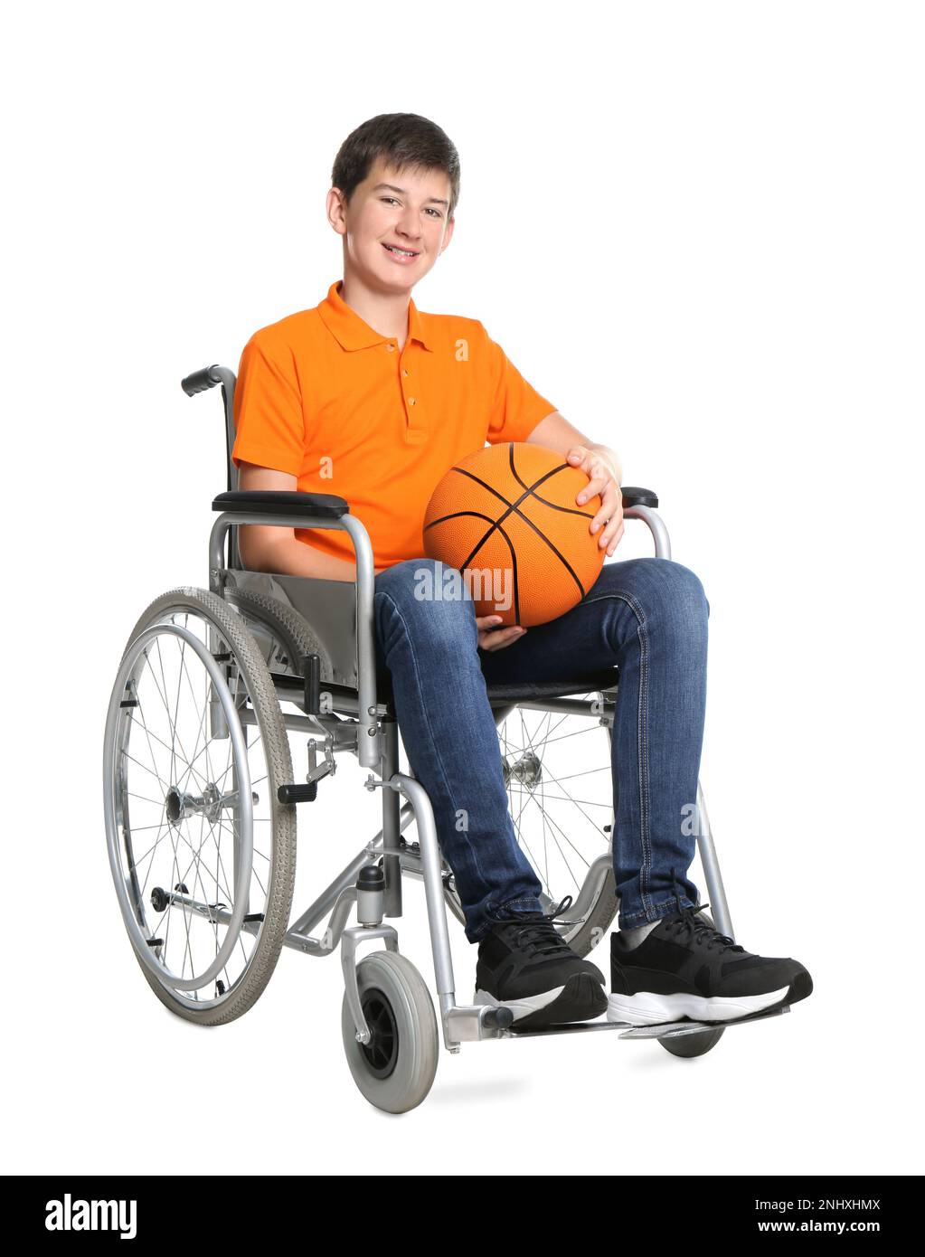Disabled teenage boy in wheelchair with basketball ball on white background Stock Photo