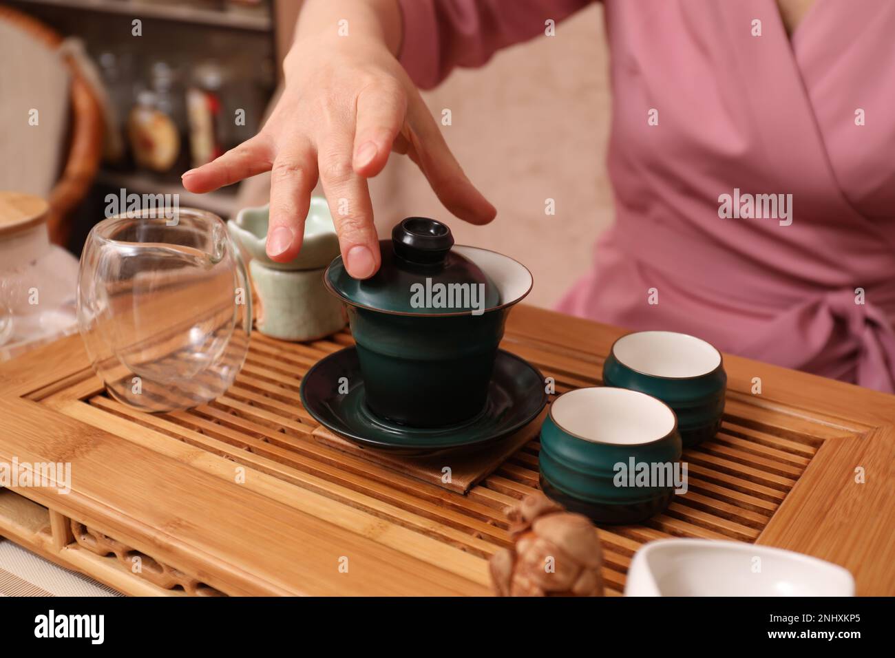 Master conducting traditional tea ceremony at table, closeup Stock