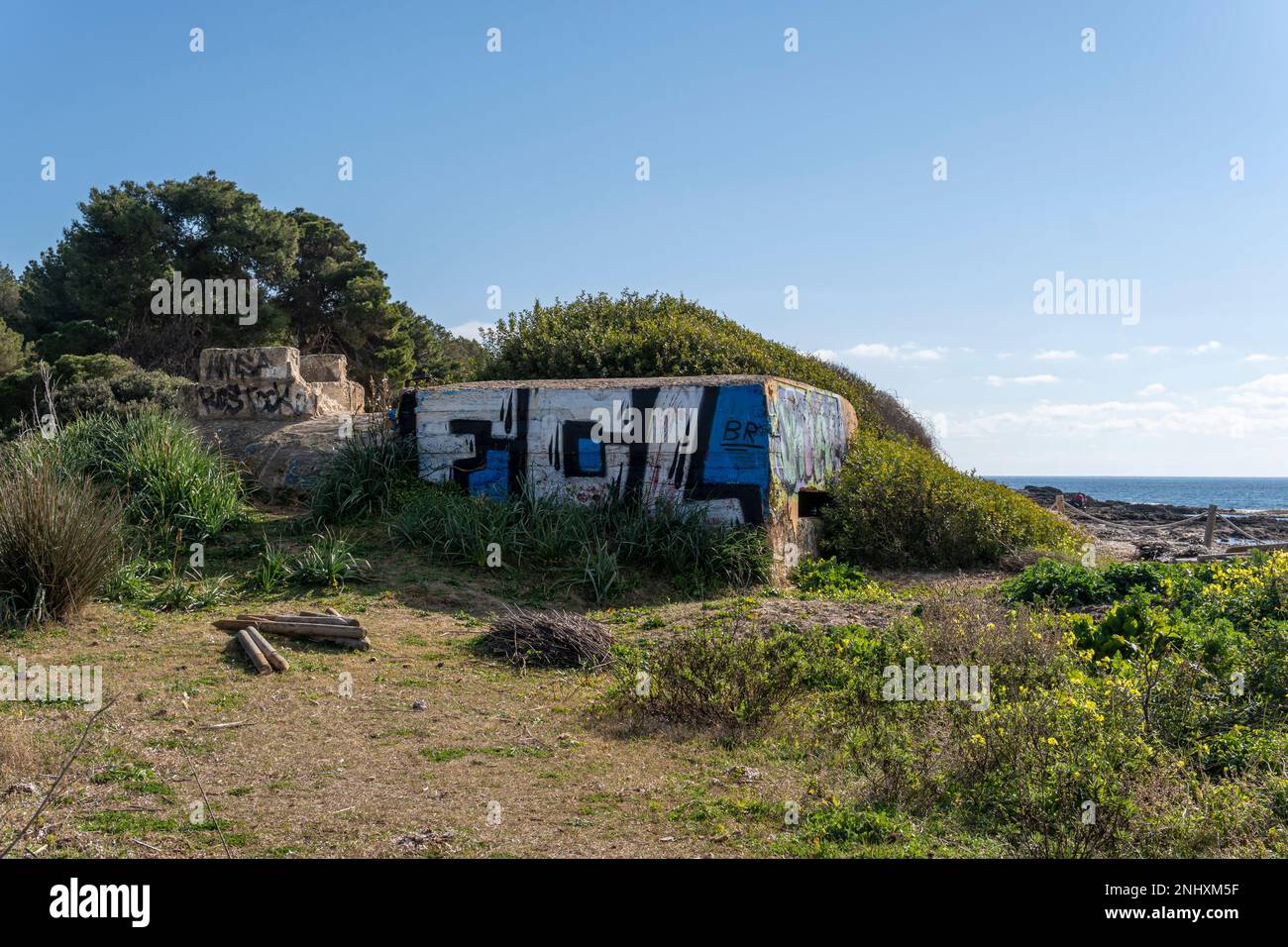 Sa Coma, Spain; february 17 2023: Former Spanish Civil War bunker on the beach of Sa Coma at dawn. Island of Mallorca, Spain Stock Photo