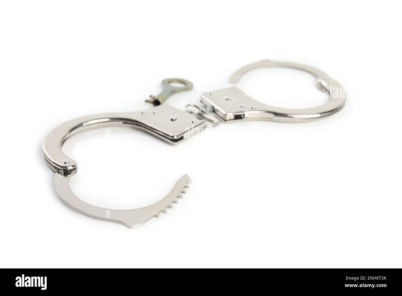 Classic chain handcuffs with key on white background Stock Photo Alamy