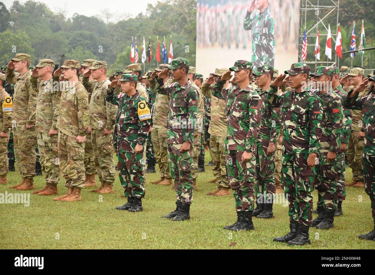 U.S. Army soldiers and TNI soldiers salute in formation, signifying the