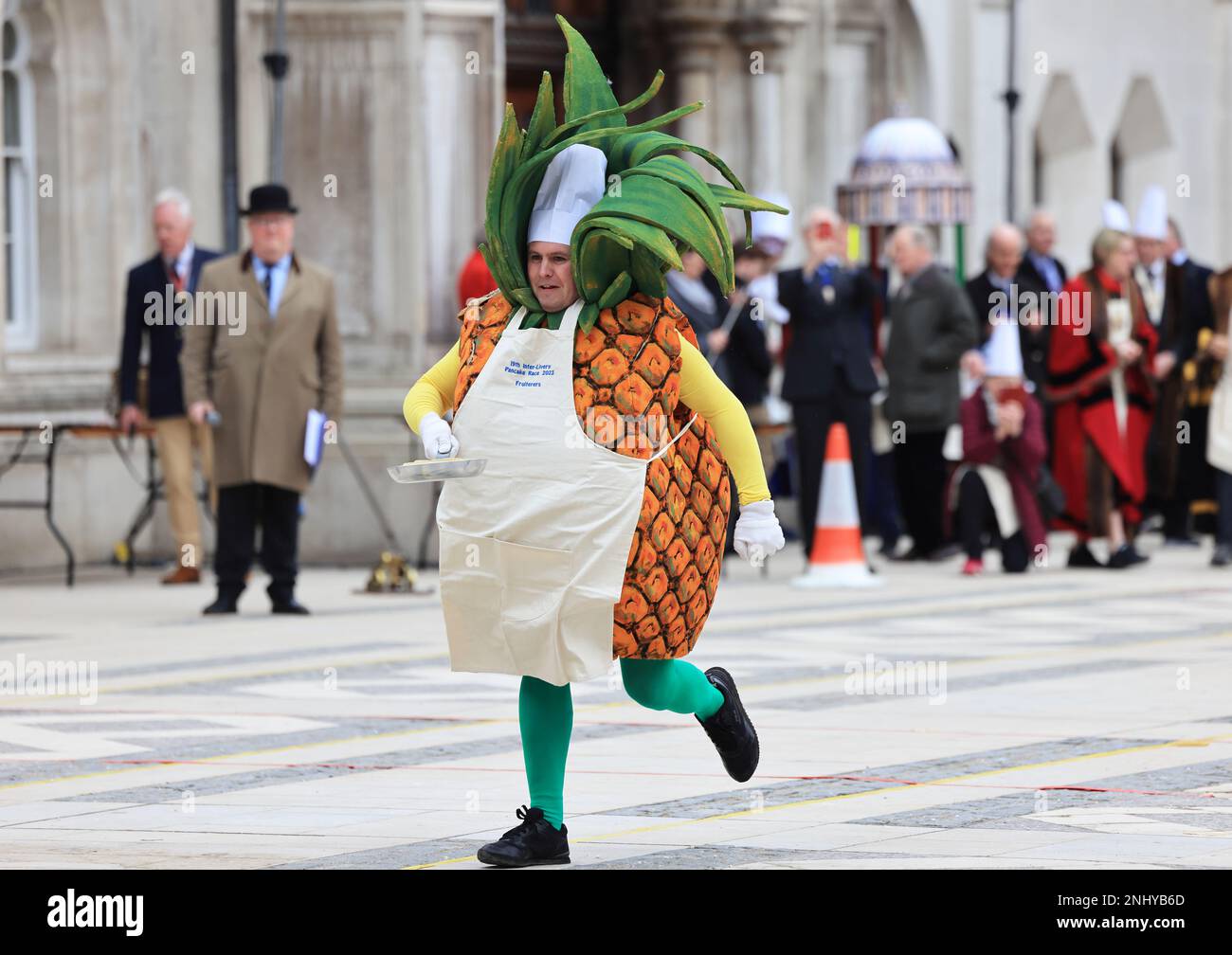 The quirky Inter Livery Pancake Race hosted by the Worshipful Company of Poulters, at Guildhall Yard, for Shrove Tuesday, 2023, in the Square Mile, London, UK Stock Photo