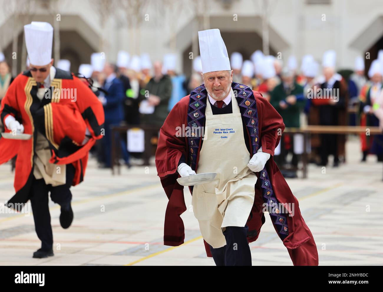 The quirky Inter Livery Pancake Race hosted by the Worshipful Company of Poulters, at Guildhall Yard, for Shrove Tuesday, 2023, in the Square Mile, London, UK Stock Photo